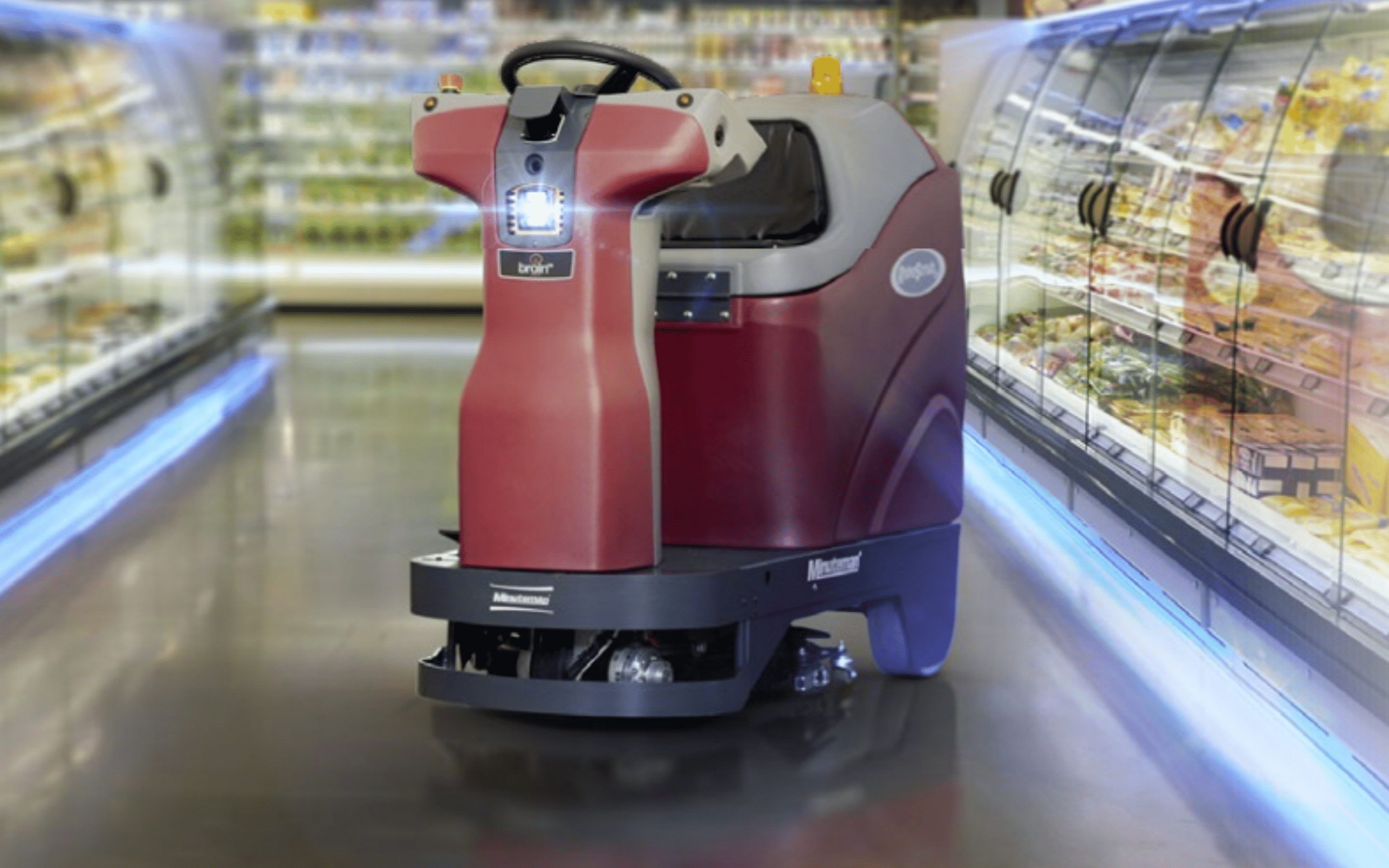 autonomous commercial floor scrubber in grocery store aisle